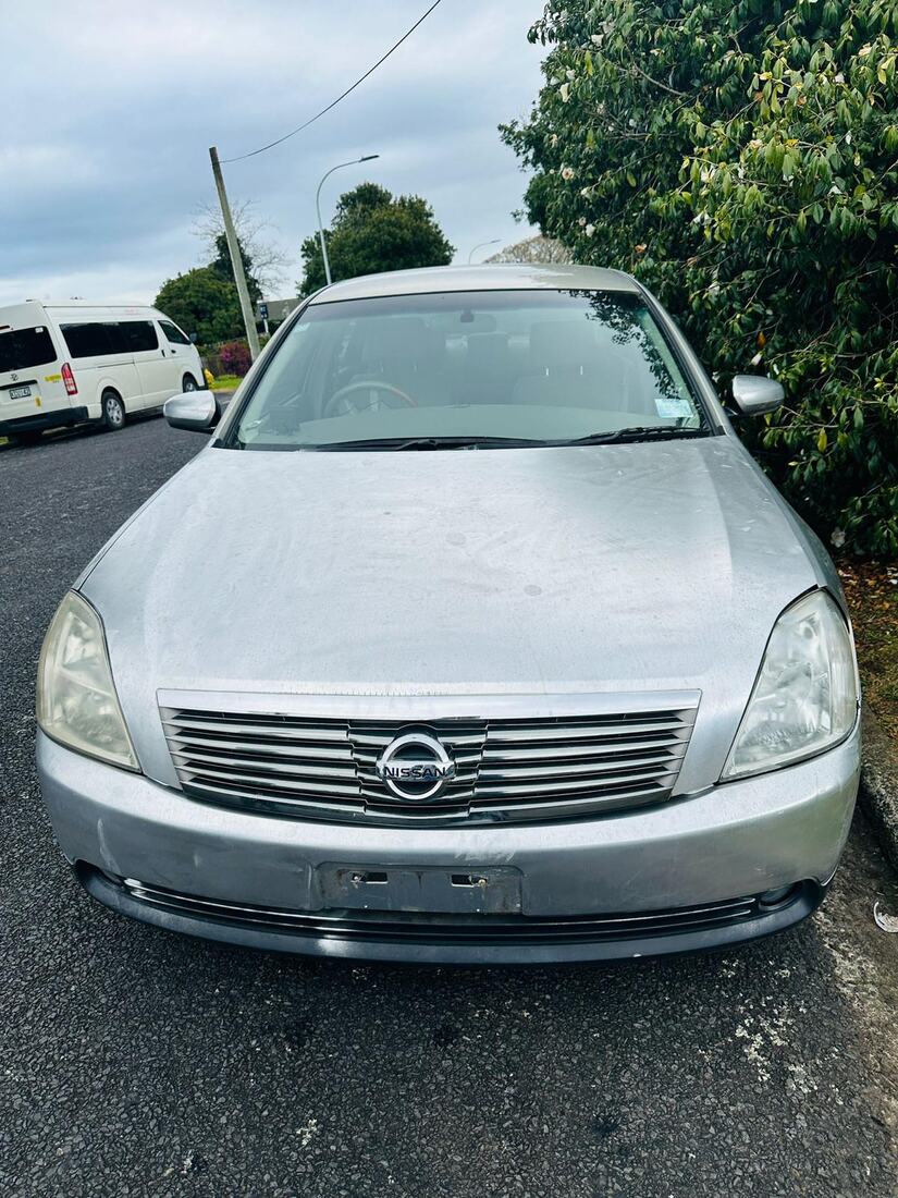 Unwanted silver Nissan sedan parked on a Whakatāne street before sale