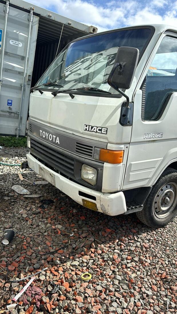 Old Toyota Hiace light truck parked on gravel ready for removal