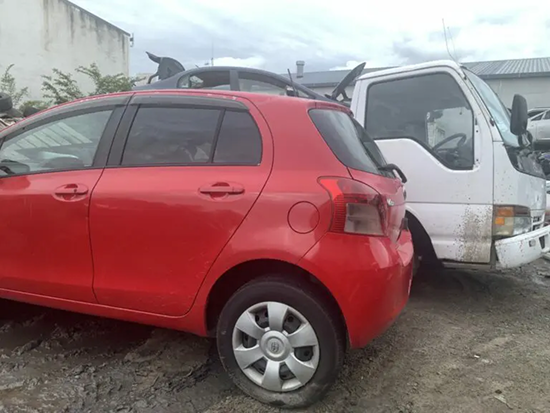 Tow truck transporting three scrap cars for removal in Whakatane